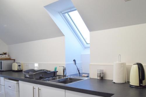 a kitchen with a sink and a window at Cosy self-contained flat in Kirriemuir in Kirriemuir