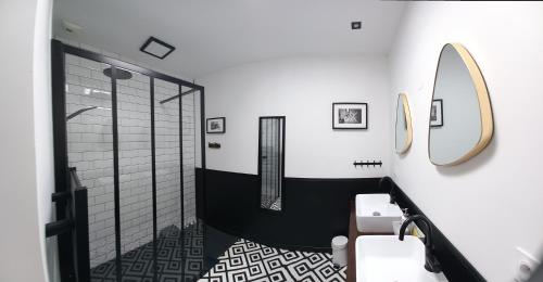 a bathroom with a shower and a sink and a mirror at La villa du pressoir, classé 3 étoiles meublé de tourisme in Le Pallet