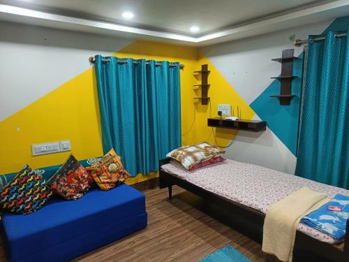 a room with a bed and a couch in it at Terrace garden & Unique 1 bedroom AC rental unit in Haldia in Haldia