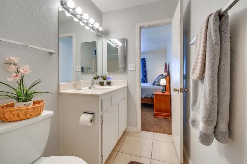 a bathroom with a sink and a toilet and a mirror at Bullhead City Home Less Than 2 Mi to Colorado River! in Bullhead City