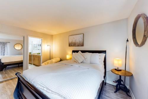 a bedroom with a large bed and a mirror at Pacific Cove Unit 111 in Los Angeles