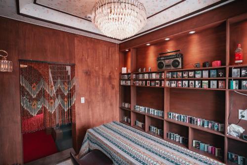 a room with a table and shelves with books at Stay Ccassette Player in Mokpo