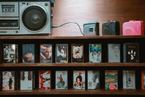 a book shelf with movies and a radio on it at Stay Ccassette Player in Mokpo