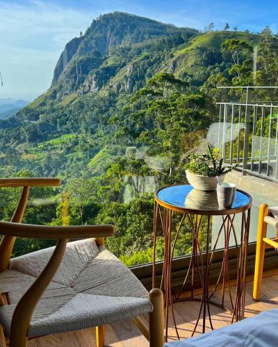 a room with a table and a view of a mountain at HIDE ELLA Hotel & Resort in Ella