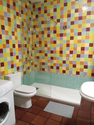 a bathroom with a toilet and a shower and a sink at Famarabeach in Famara