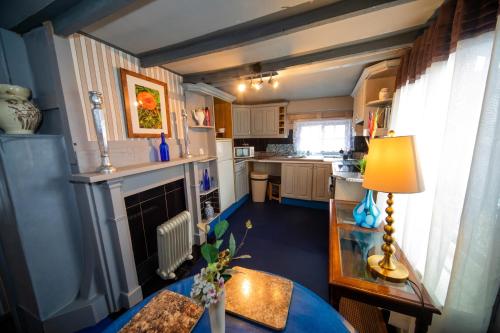 a small kitchen with a table and a lamp at The Secret Garden in Newark upon Trent