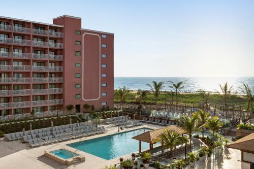 an aerial view of the resort with a swimming pool and the ocean at Holiday Inn Ocean City, an IHG Hotel in Ocean City