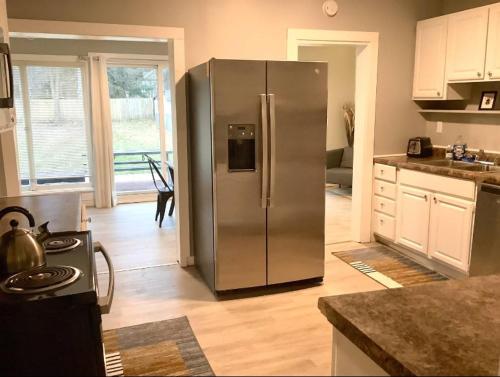 a kitchen with a stainless steel refrigerator in a kitchen at Revere Lower in Cleveland