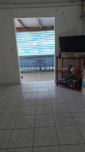 a living room with a large window and a tiled floor at les héritiers in Trois-Rivières