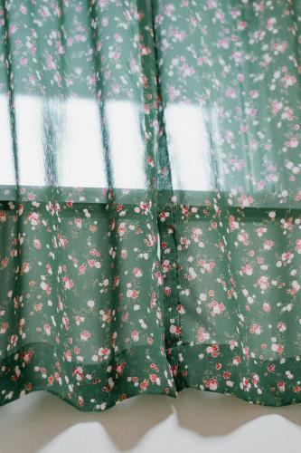 a pair of curtains with pink flowers on them at Stay Ccassette Player in Mokpo