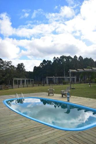 a swimming pool in a park with a playground at Cabaña Familiar en Complejo Los Tres Rubios in Rivera