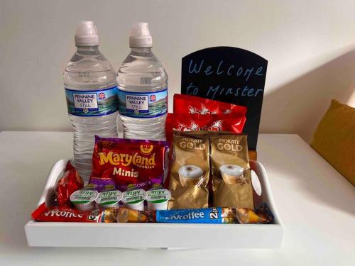 a cooler with two bottles of water and snacks at Minster Hilltop Apartment in Minster