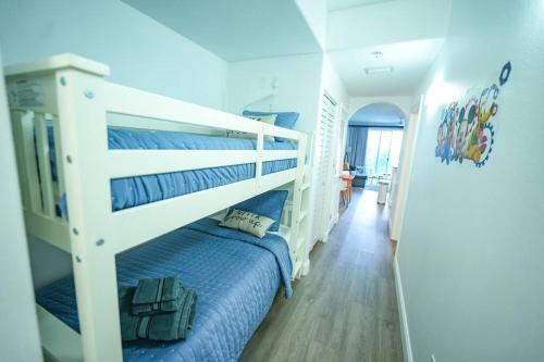 a bedroom with a bunk bed with blue sheets at Apartment 5 min away from Disney 1st Floor in Orlando