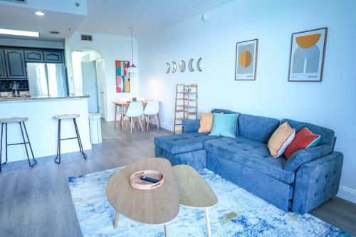 a living room with a blue couch and a table at Apartment 5 min away from Disney 1st Floor in Orlando