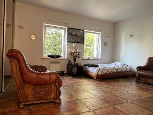 a living room with two chairs and a couch at Apartament Zloty Pociag in Wałbrzych
