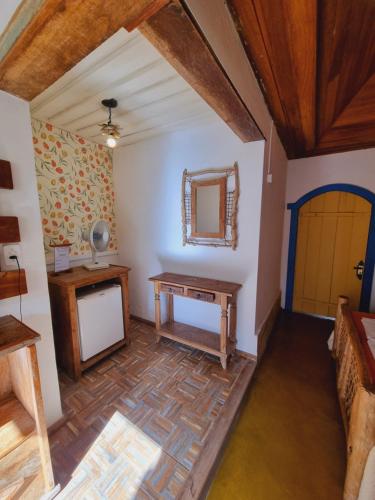 a room with a table and a mirror at Pousada Cipó Artes in Prados