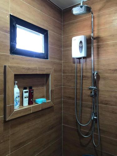 a bathroom with a shower with a window and a shower at Luxury Penthouse With View&Starlink in Dapa