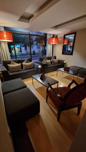 a living room with couches and chairs and a table at Hotel Principe Lisboa in Lisbon