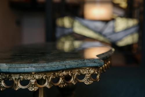a close up of a table in front of a couch at Excelsior INN in Turda