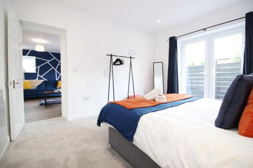 a bedroom with a large bed and a large window at Casa di pietra - Cardiff City centre apartment with patio, Free private parking in Cardiff