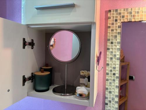 a bathroom with a mirror in a doll house at Principessa Como close to the lake in Como