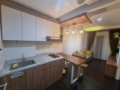 a kitchen with a sink and a counter top at SIGNATURE PARK GRANDE MT.Haryono in Jakarta