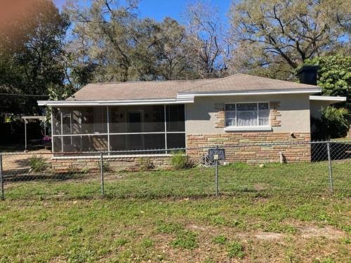 a house with a fence in front of it at Hidden Gem 3br/1b+Jacuzzi+busch garden+fishn+kayak in Tampa