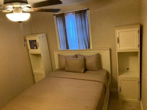 a small bed in a room with a window at Hidden Gem 3br/1b+Jacuzzi+busch garden+fishn+kayak in Tampa