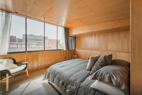 a bedroom with a bed and a large window at DIB Collection in Mexico City