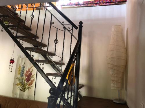 a staircase in a home with a white wall at Villa Melpo in Likodhrómion