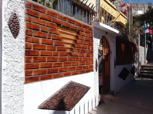 a brick wall on the side of a building at Esterlina in Cusco