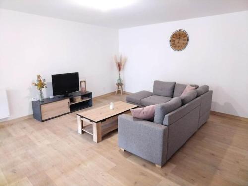 a living room with a couch and a coffee table at Au chatet ! (Hattonchatel) in Vigneulles-lès-Hattonchâtel