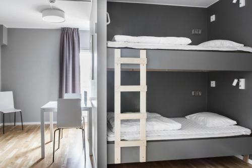 a room with bunk beds and a desk at Linnéplatsens Hotell & Vandrarhem in Gothenburg