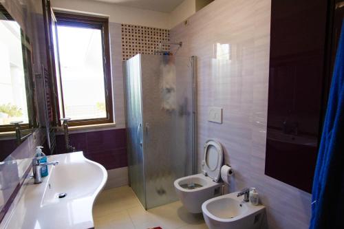 a bathroom with a sink and a toilet and a shower at Oasi della pace in Bisceglie