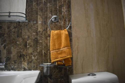 a bathroom with a towel hanging on a wall at Atithi Stay By Kasa Lusso - Luxury 2 BHK In Faridabad in Faridabad