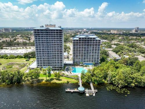 an aerial view of two tall buildings on the water at Orlando Blue Heron condo 1 mile from Disney in Orlando
