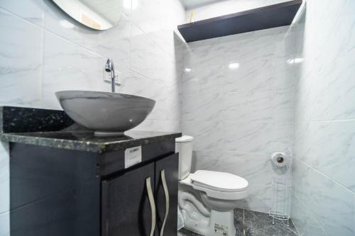 a bathroom with a sink and a toilet at Edificio SantaMarta Medellín in Medellín