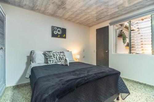 a bedroom with a bed and a window at Edificio SantaMarta Medellín in Medellín