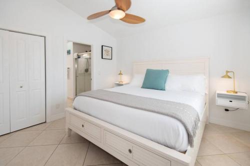 a bedroom with a large bed with a ceiling fan at Ultimate Group Escape - 8BD Oceanfront Beach House in Fort Pierce