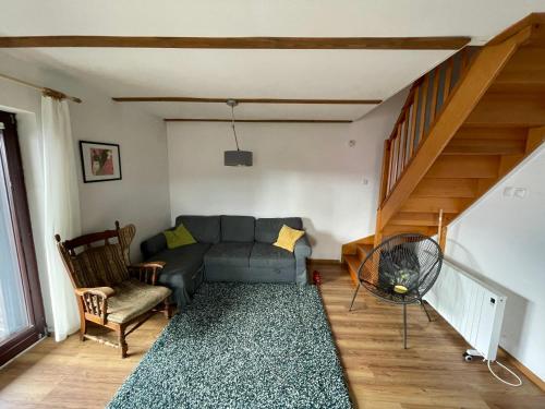 ein Wohnzimmer mit einem Sofa und einer Treppe in der Unterkunft Dom Znajomych - cały dla Ciebie, ogrodzony, wygodny in Złatna