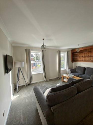a living room with two couches and a tv at The Castle in Killingworth