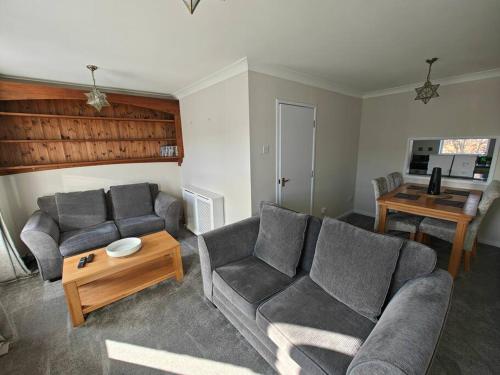 a living room with two couches and a table at The Castle in Killingworth
