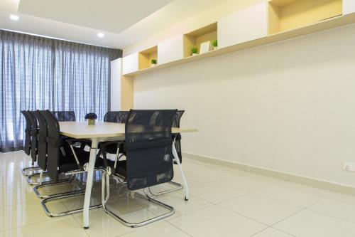 a conference room with a table and black chairs at Paradigm Mall 1BR-Poolview-Netflix-WiFi by JB RelaX Homestay in Johor Bahru