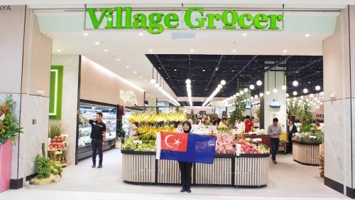 a woman holding a sign in a v mileage grocery store at Paradigm Mall 1BR-Poolview-Netflix-WiFi by JB RelaX Homestay in Johor Bahru