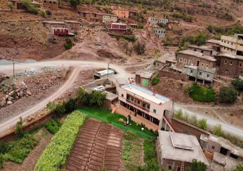 an aerial view of a village with a road and houses at Guest House Imdoukal in Aït Tamellil