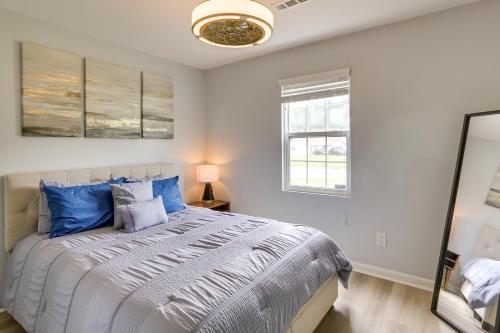 a bedroom with a large bed with blue pillows at Greensboro Vacation Rental with Patio, Yard! in Greensboro