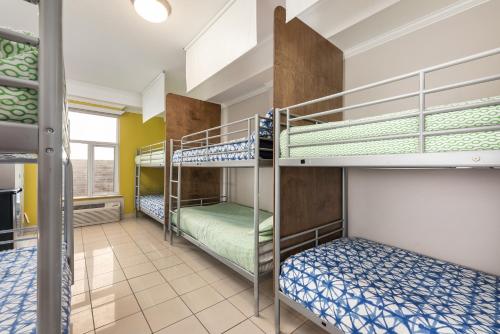 a room with three bunk beds in a building at Samesun Montreal Hotel & Hostel in Montréal