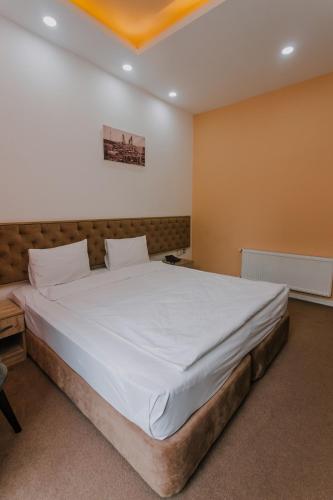 a bedroom with a large white bed in a room at Madina-ZamZam Halal Hotels Group in Baku