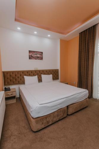 a bedroom with a large bed in a room at Madina-ZamZam Halal Hotels Group in Baku