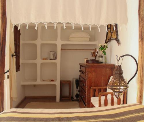 a bedroom with a bed and a dresser in a room at Riad Baladin in Essaouira